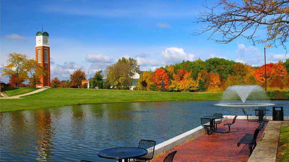 Scenic park with colorful autumn trees and pond.