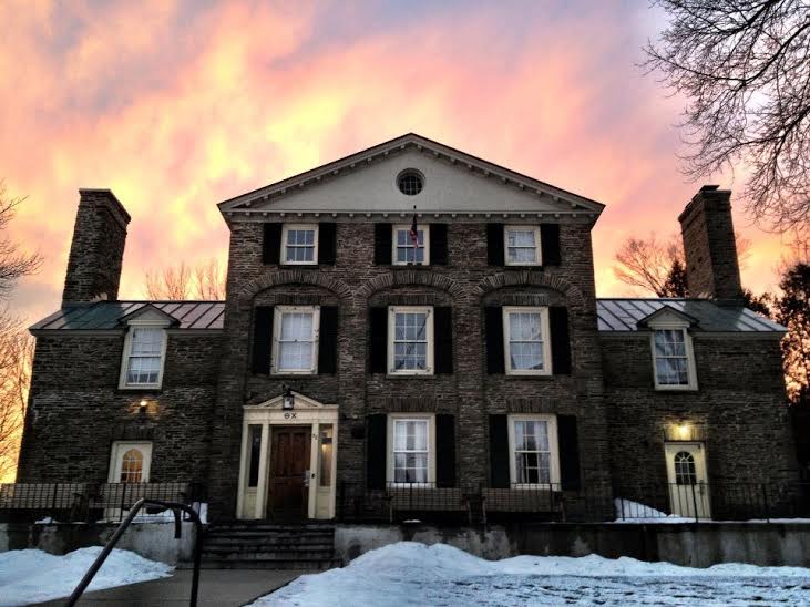 Historic building with sunset sky and snow.