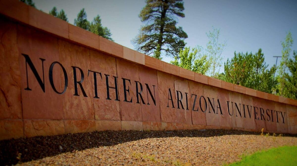 Northern Arizona University entrance sign in outdoor setting.