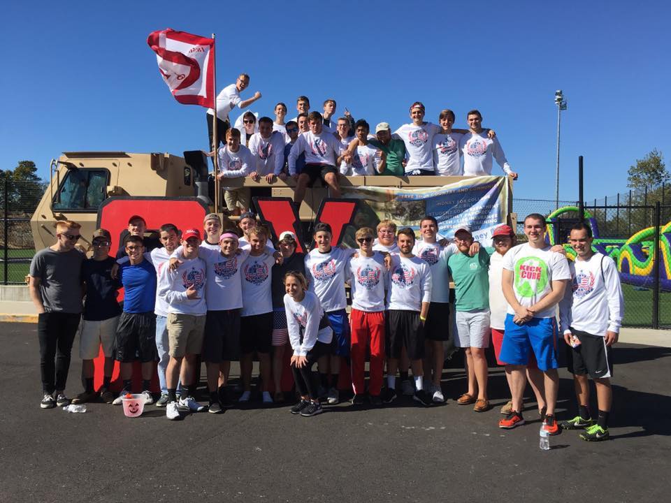 Group of students celebrating at outdoor event.