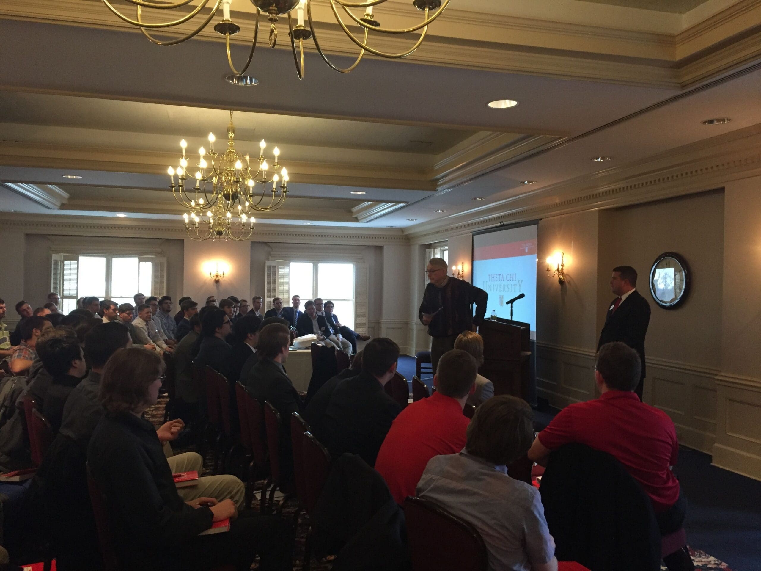 Business seminar with audience in elegant venue.