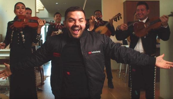 Jack Dunlop Man celebrating with mariachi band in background.