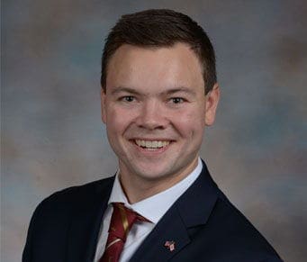 Jacob Barker Smiling young man in formal attire portrait.