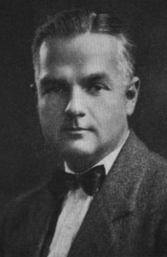 Black and white portrait of a man in a bow tie.