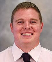 Smiling young man in a professional shirt and tie.