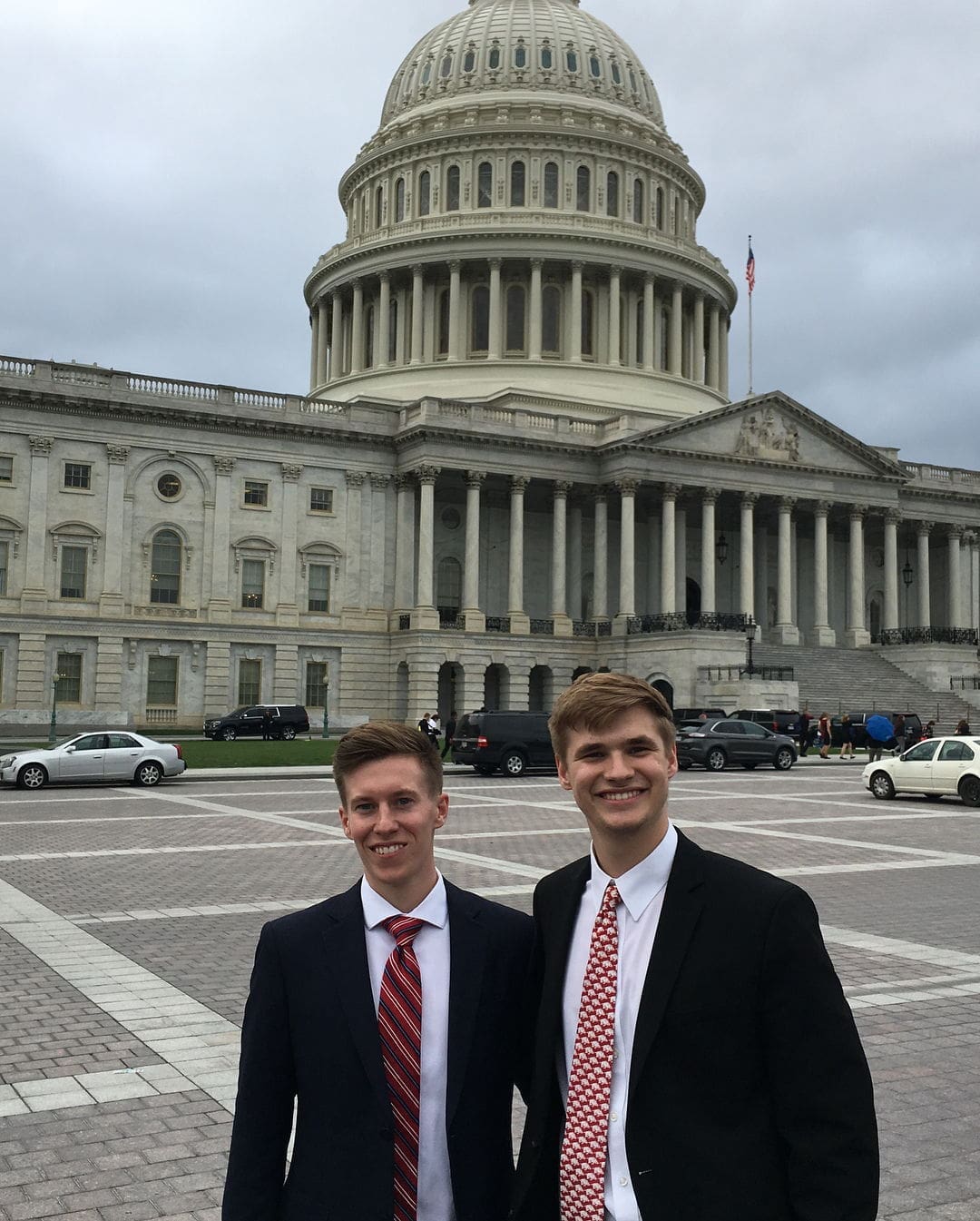 Jared Pinkerton - Brandon McCoy Two men in suits at the U.S. Capitol.