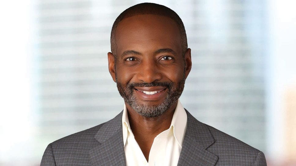 Jeff Perry Smiling man in a gray suit with a beard.