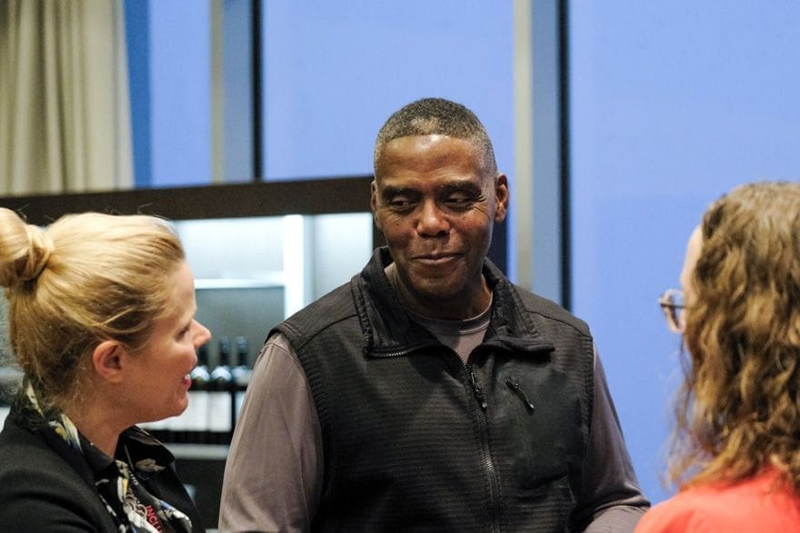 James Banks Man engaging in conversation at a social event.