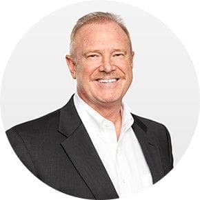 Professional man smiling in business attire.