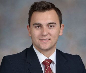 John Schoenle Professional headshot of a young man in suit.
