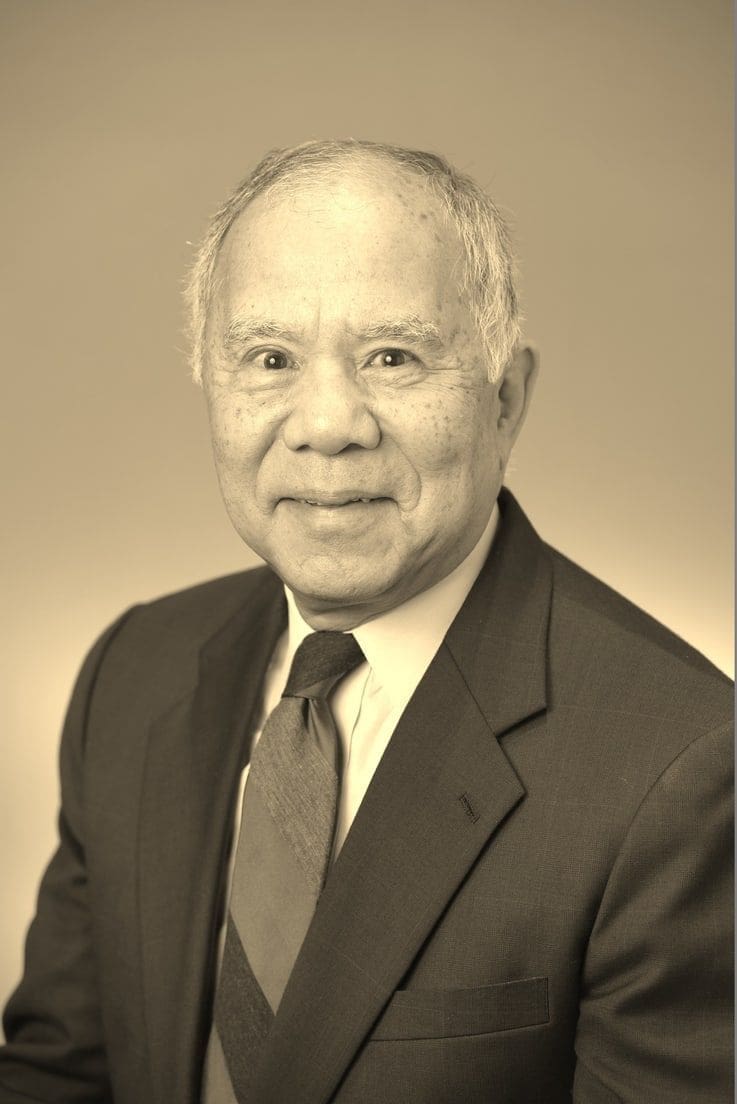 Professional portrait of an older Asian man.