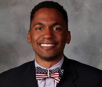 Smiling man in suit with patriotic bow tie.