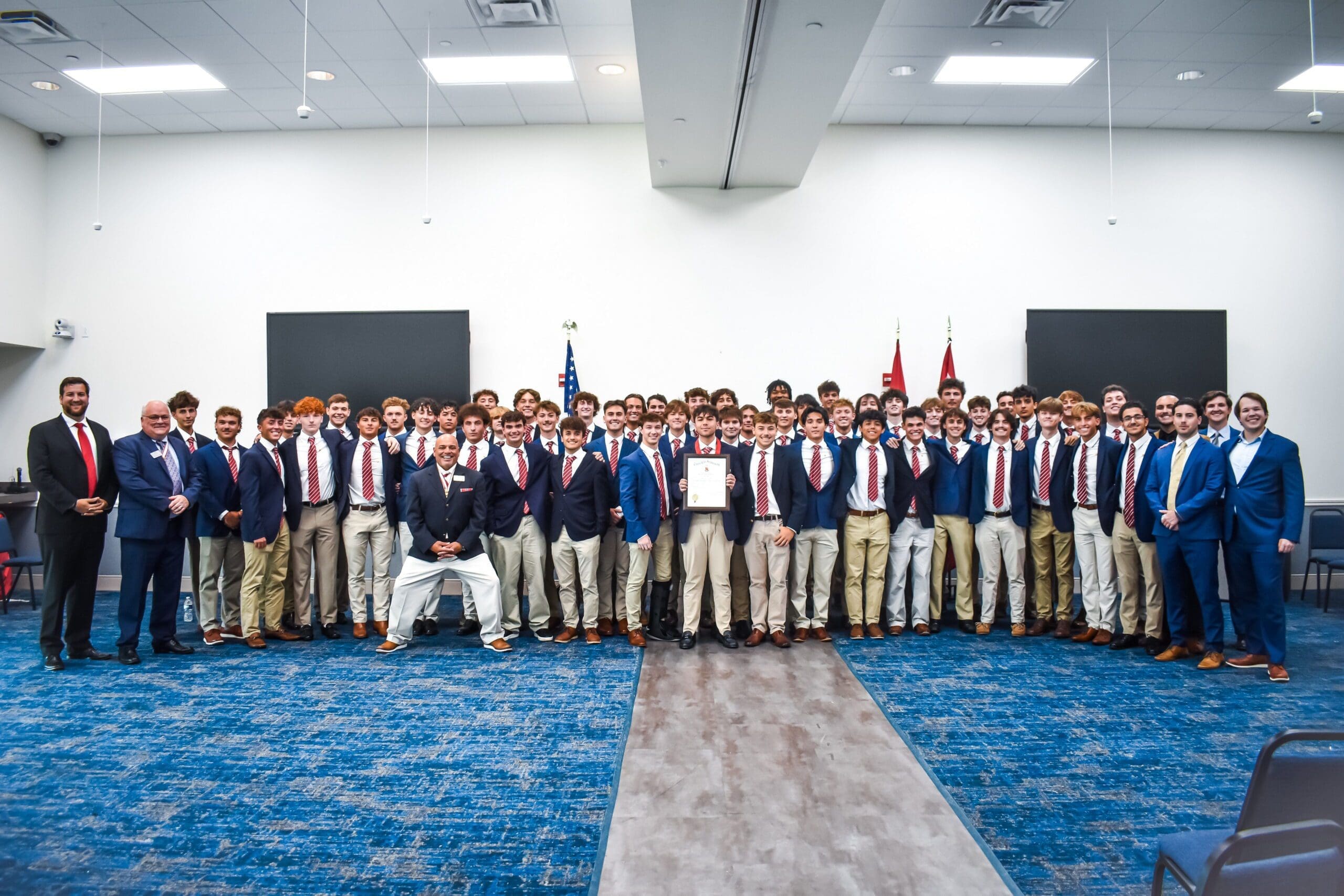 Group of students in formal attire celebrating achievement.