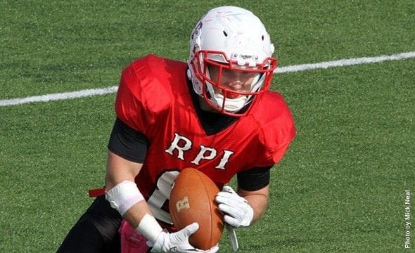 RPI football player preparing to pass ball.