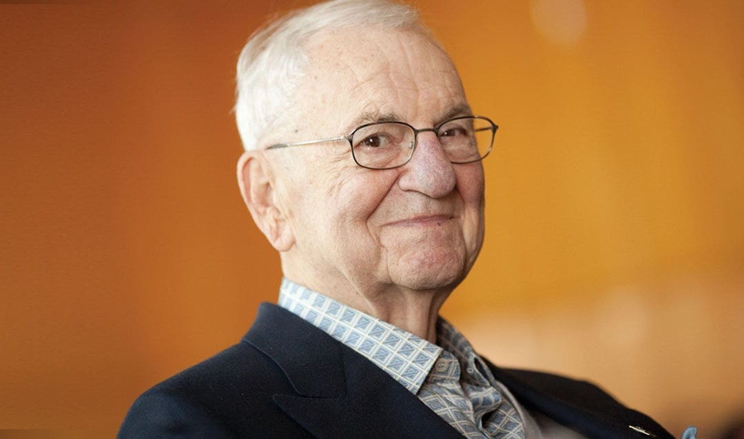 Lee Iacocca Smiling elderly man with glasses and patterned shirt.