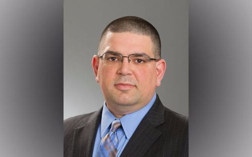 Professional man in a suit with glasses.