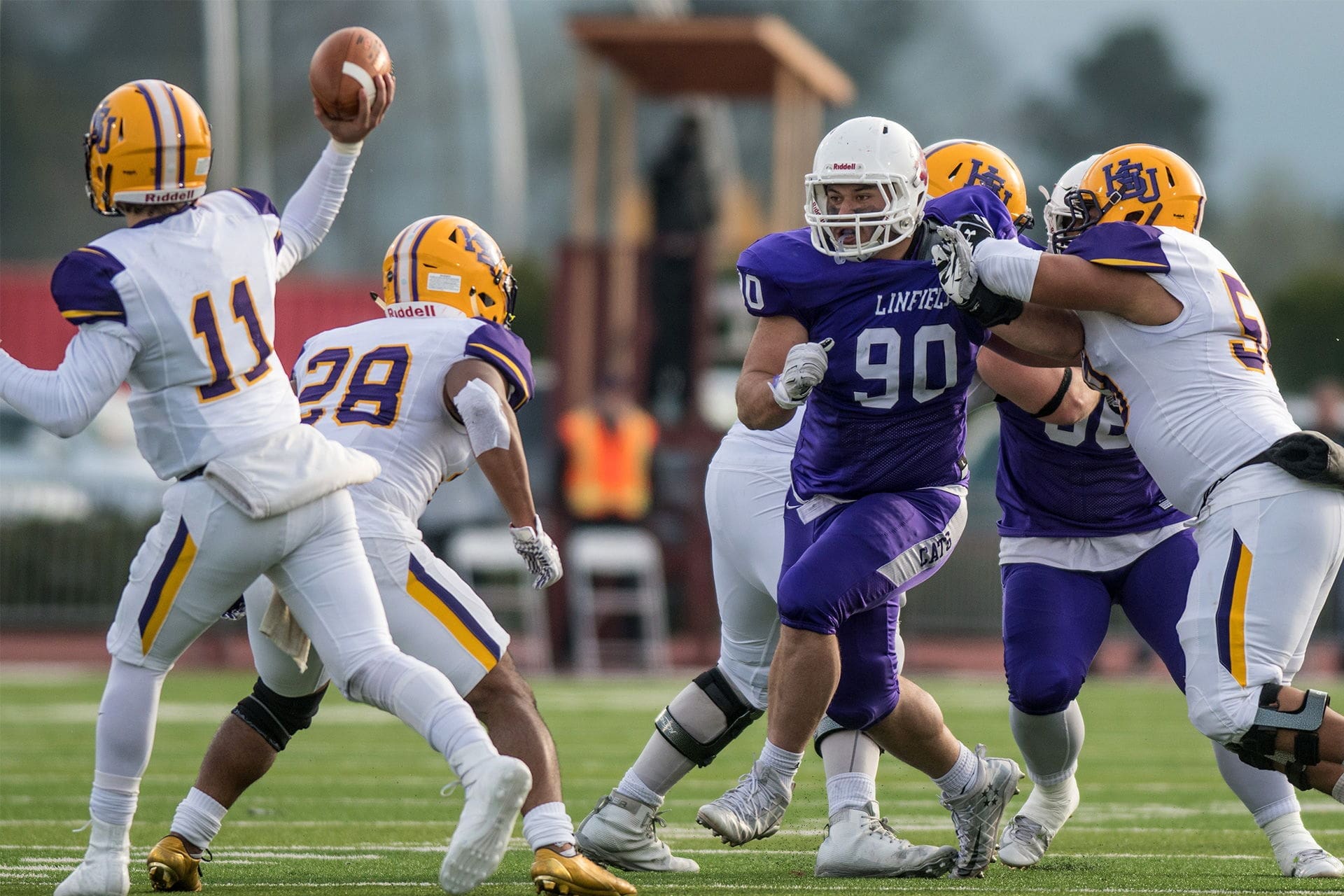 Linfield - Chirs Stinchcomb (2) Quarterback throws pass during football game action.