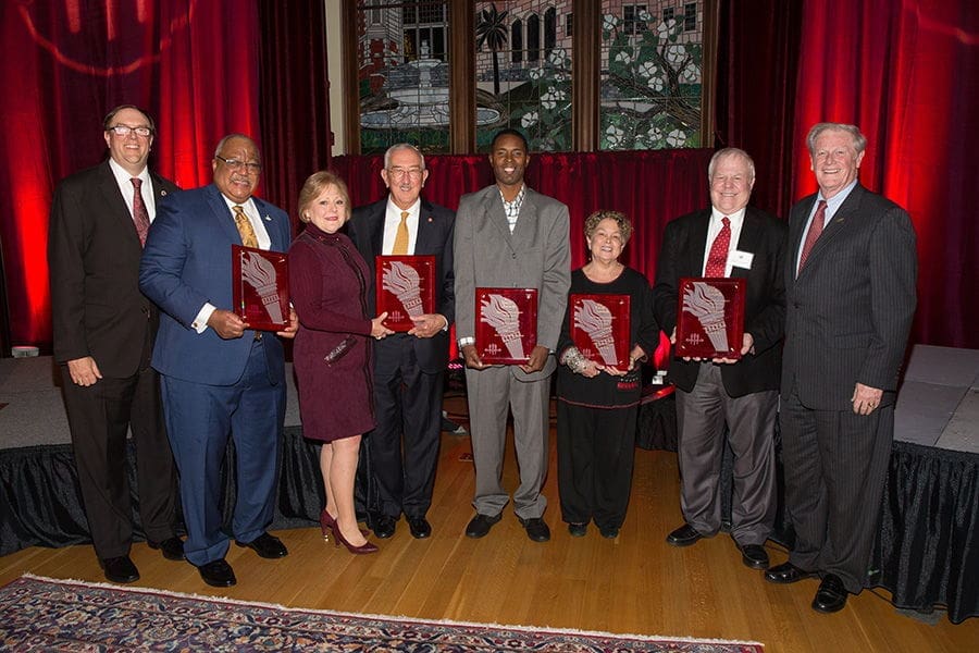 Mark Hillis Award (1) Award recipients posing with plaques at an event.