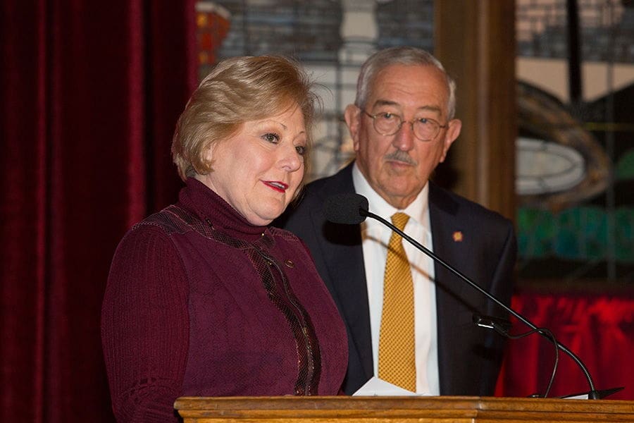 Mark Hillis Award (2) Two speakers at a formal event, engaging audience.