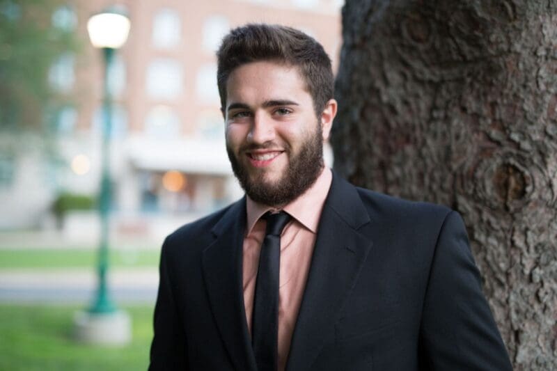 Spencer Martin in a suit outside