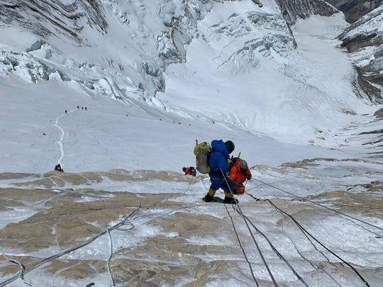 Climbers navigating icy slopes on Mount Everest.