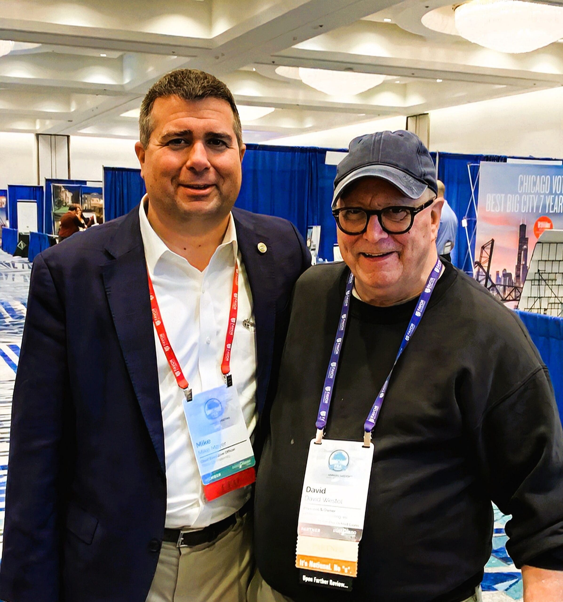 Two men posing at a conference event.