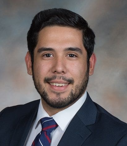 Professional man in a suit smiling for portrait.
