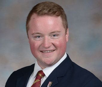 Mitch Nolan Smiling young man in formal attire portrait.