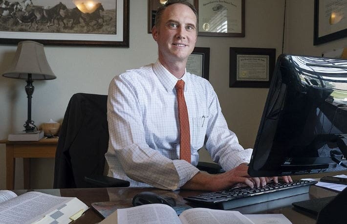 Nate Hibben Professional man working at a desk with computer.