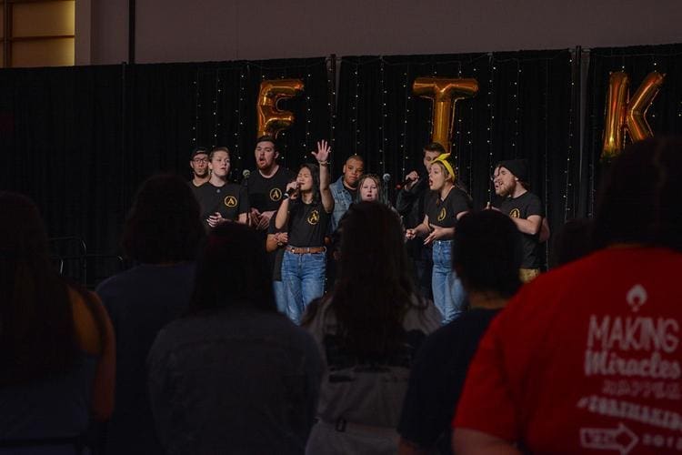 Delta Rho - Dance Marathon Group performance at a live event stage.