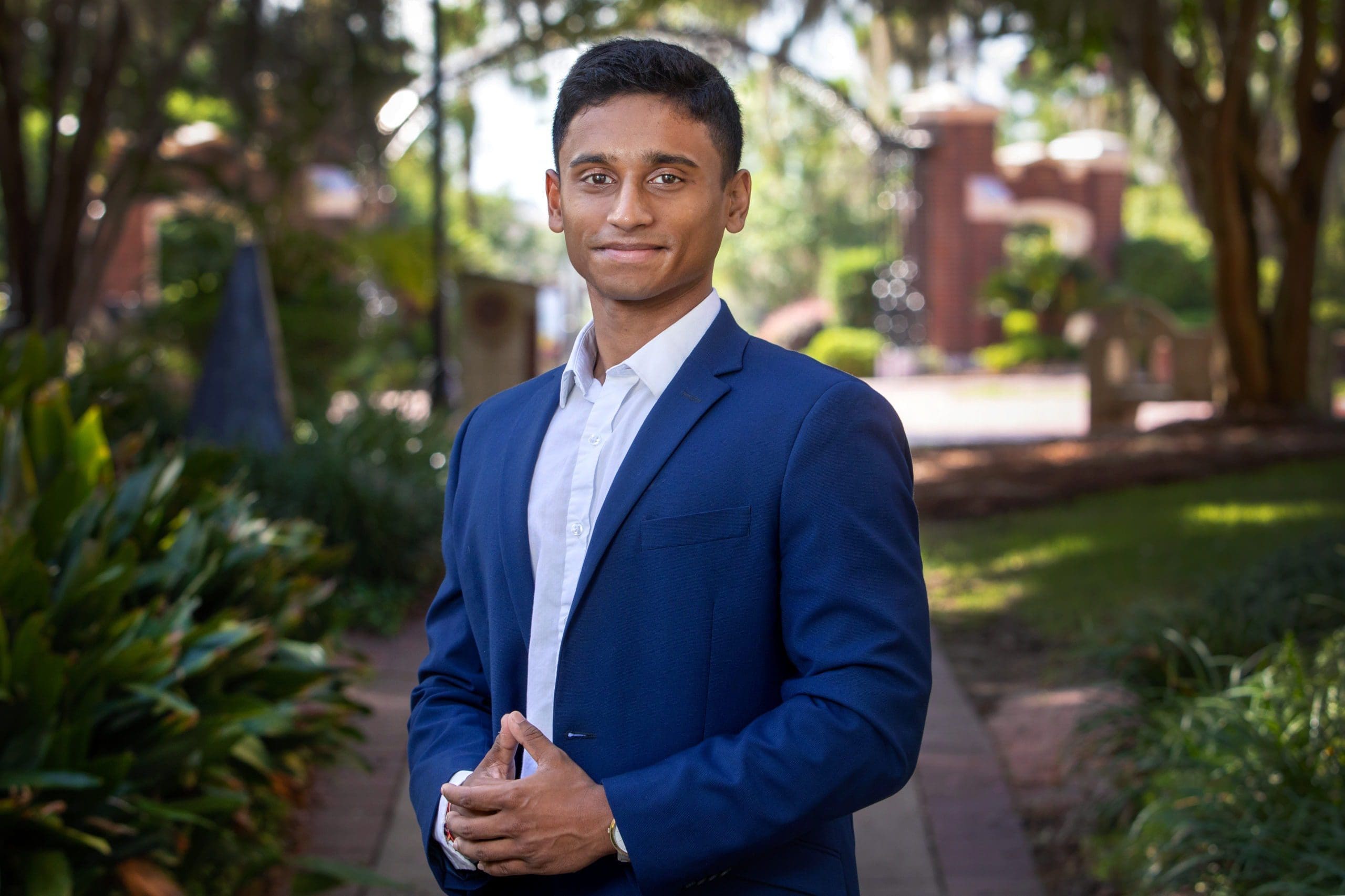 Young man in a blue suit outdoors.