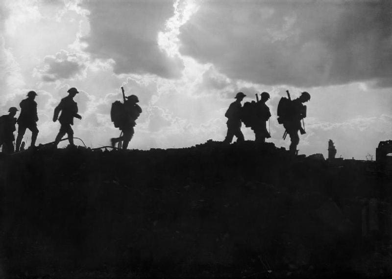 Over There Soldiers marching silhouetted against dramatic sky.