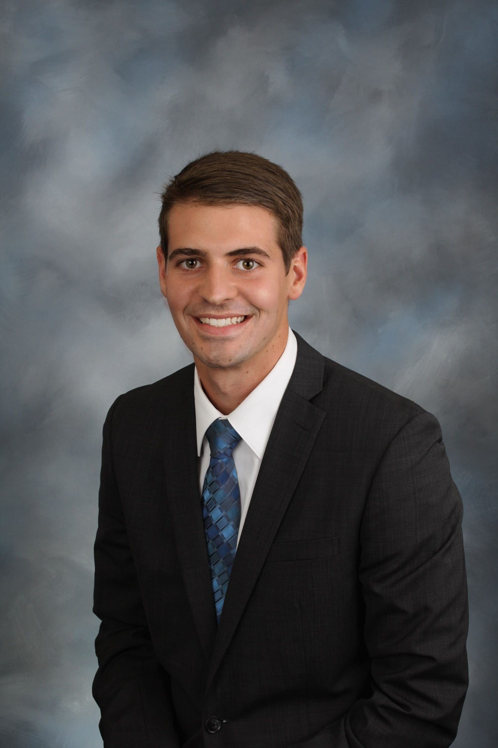 Professional man in suit with blue tie.
