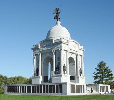 Historic monument with dome and statues.