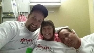 Smiling group photo supporting cancer awareness initiative.