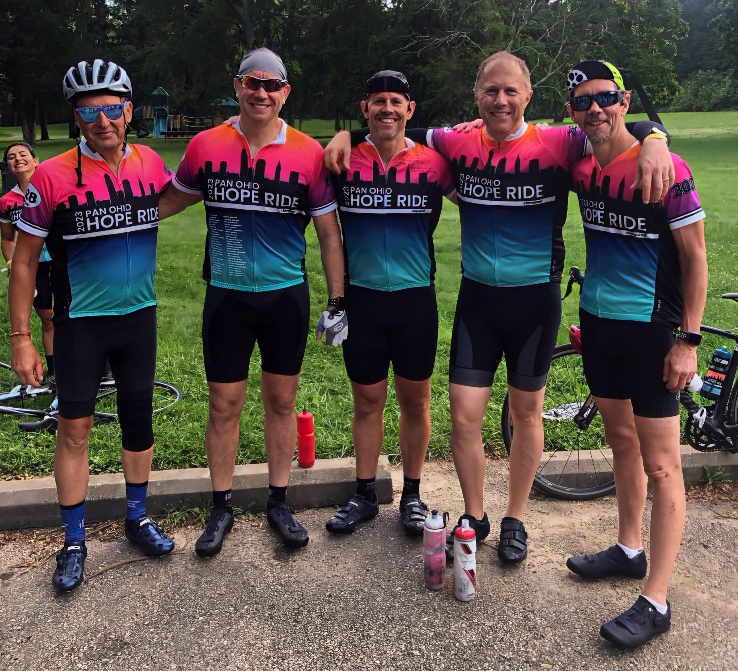 Cyclists in matching jerseys at a charity event.