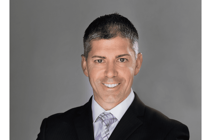 Professional man in a suit with a confident smile.