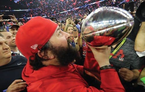 Celebrating victory with a championship trophy.
