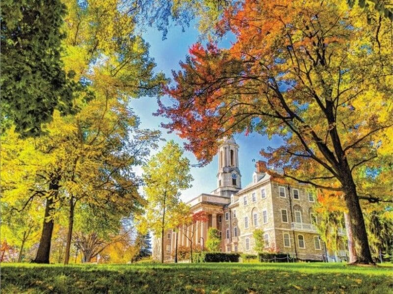 Autumn view of historic building and colorful trees.