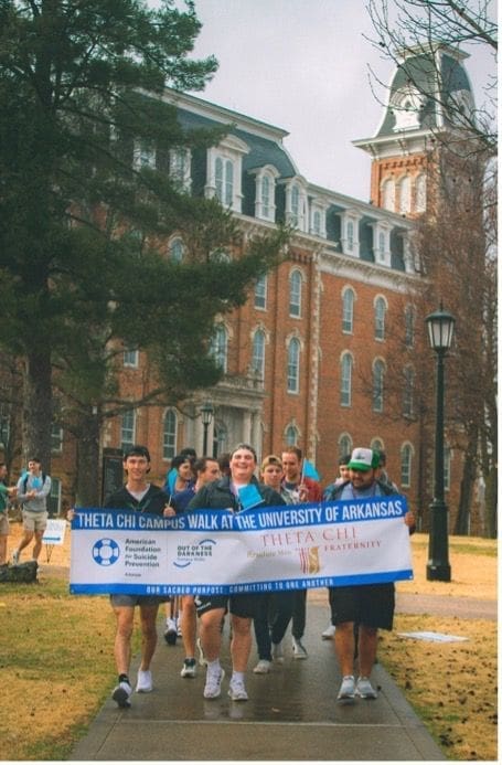 Theta Chi fraternity members walking at University of Arkansas.