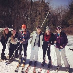 Group of friends enjoying skiing in winter.