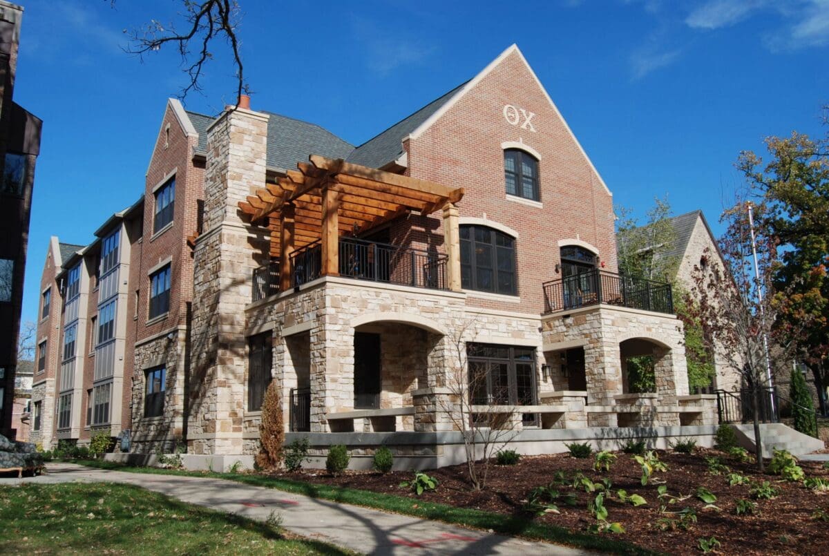 Modern brick building with stone accents and porch.