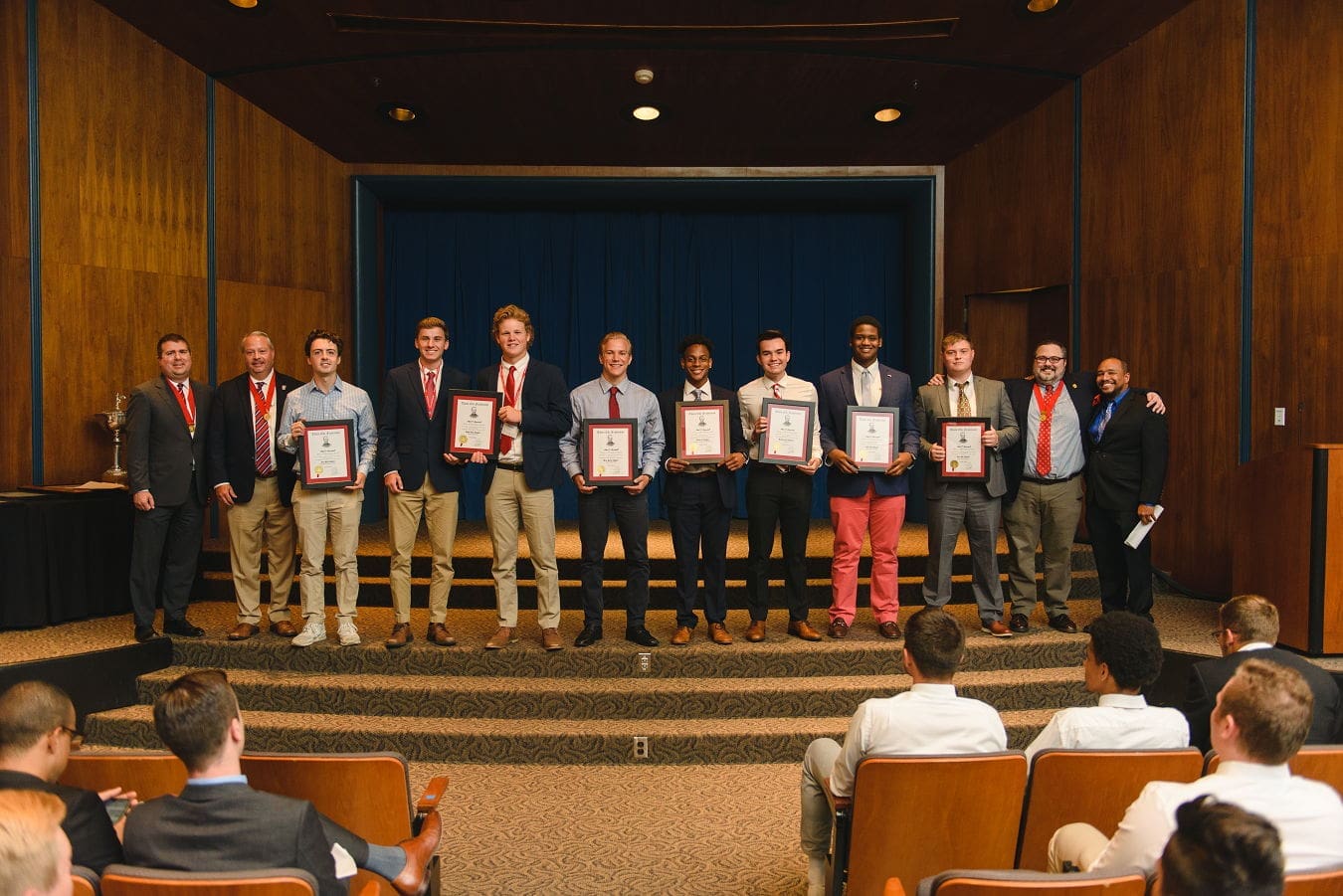 Award ceremony with students holding certificates.