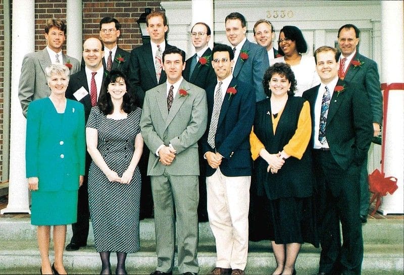 Group photo of professionals in formal attire.