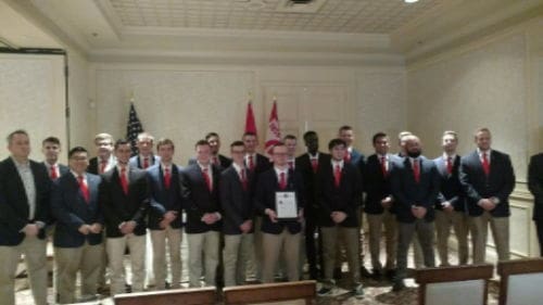 Group of men in suits at formal event.