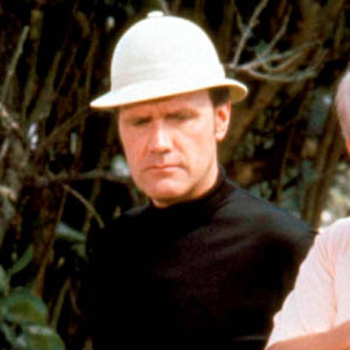 Dan Resin Man in safari hat and black shirt outdoors.