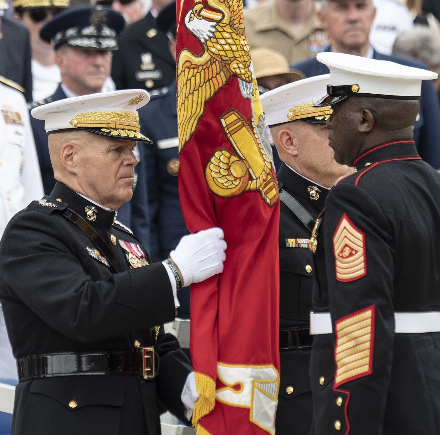Robert Neller Military ceremony with flag presentation and officers.