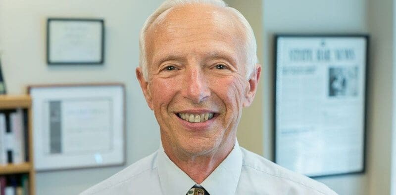 Smiling older man in a professional setting.