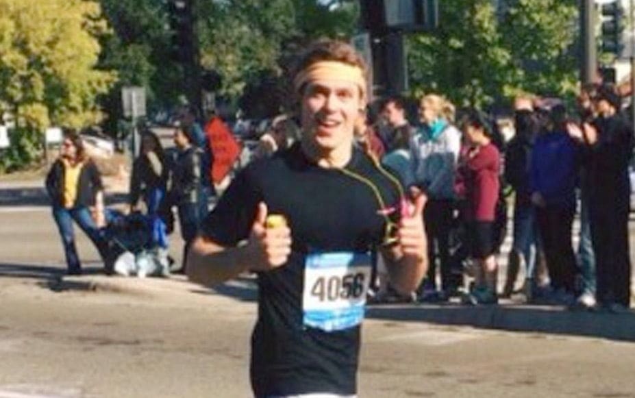 Runner giving thumbs up during a marathon event.