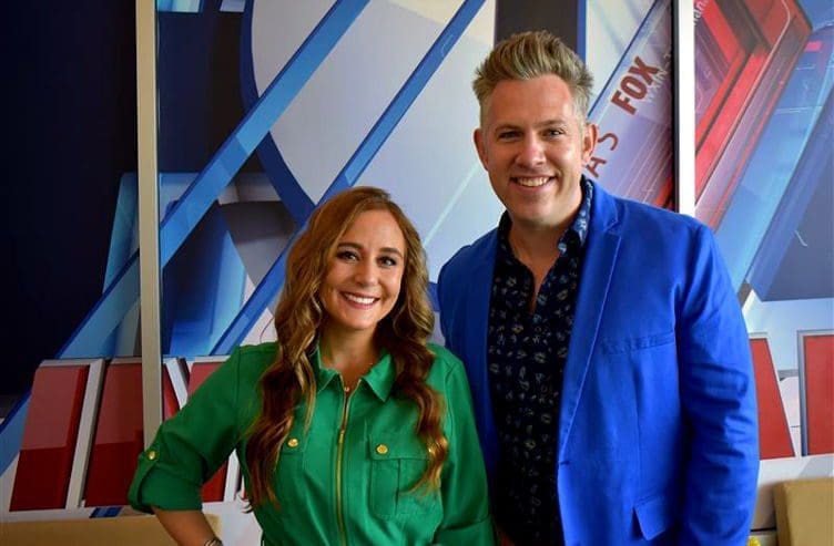 Ryan Ahlwardt Two presenters smiling in front of a studio backdrop.